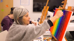 Himan Brown members in a painting class