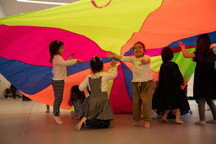 Kids under a parachute